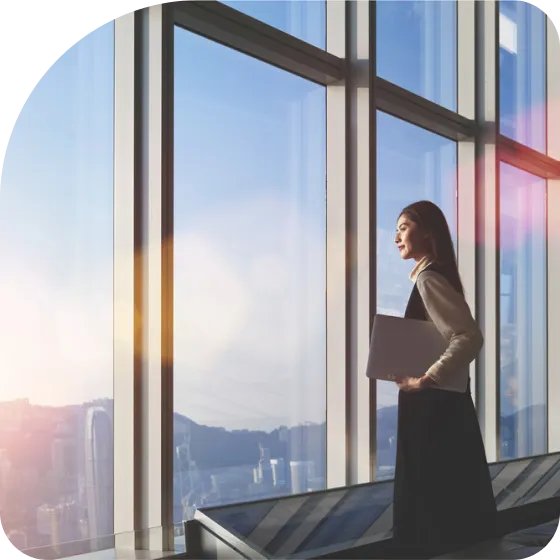 A woman looking outside of building window