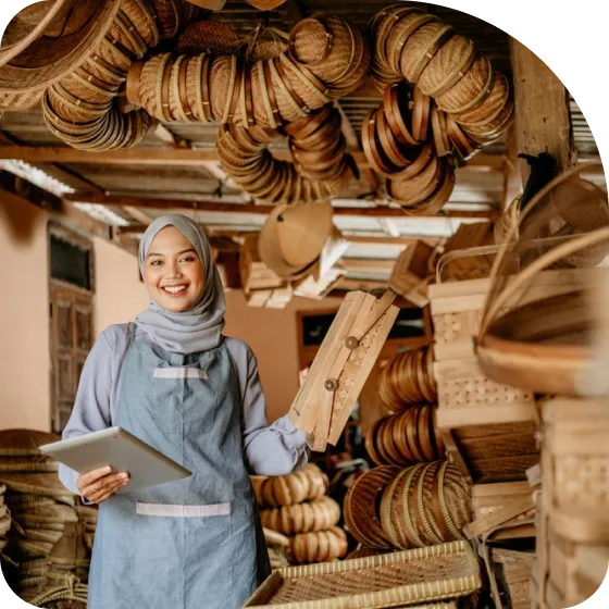 A woman in a blue dress holding a tablet.