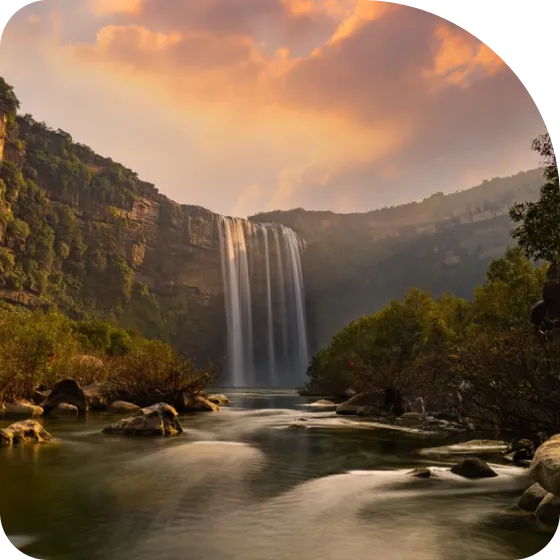 A picture of a waterfall in the middle of a river.