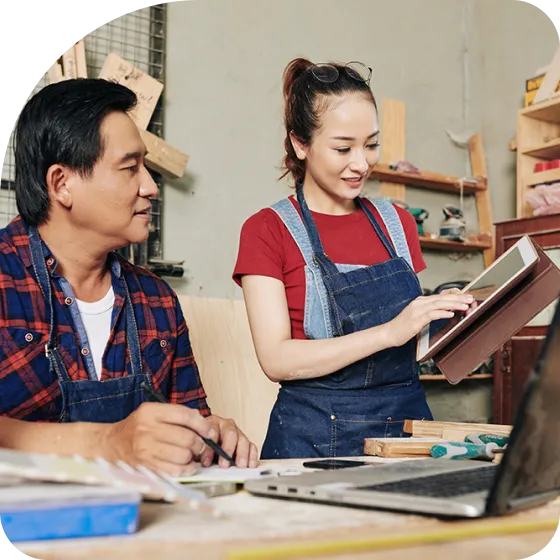 A man and a woman working on a laptop.