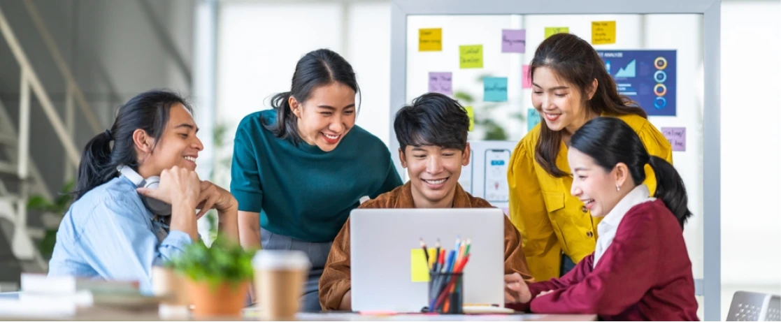 A group of people raising their hands in the air.