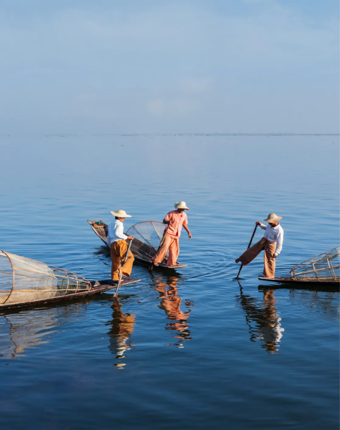 A group of people on small boats in the water.